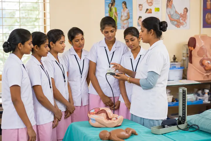 Auxiliary Nurse and Midwife students participating in practical healthcare education
